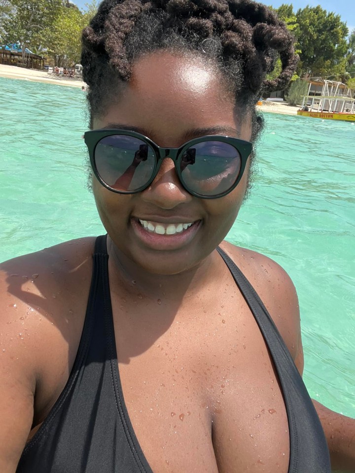 a woman wearing sunglasses and a black bikini is swimming in the ocean