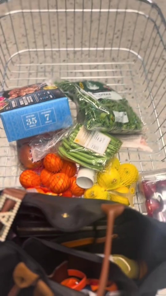 a shopping cart filled with vegetables including green beans