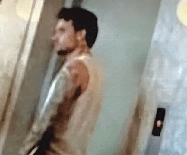 a blurry picture of a man standing in an elevator .