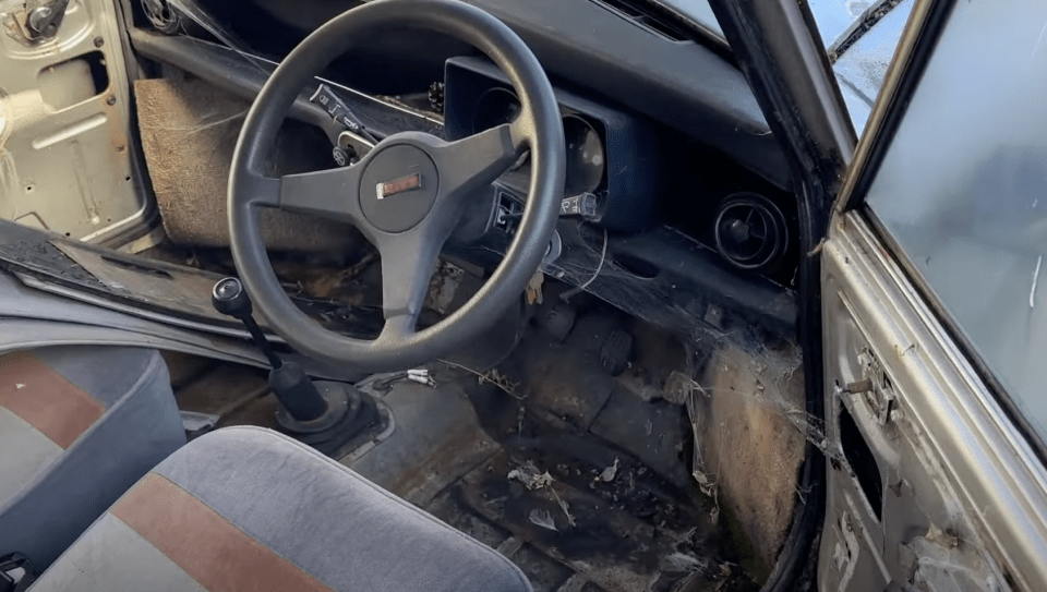 the inside of an old car with a steering wheel that says ' gmc ' on it