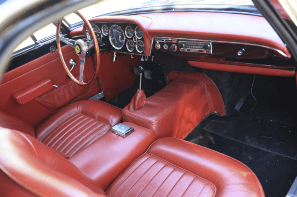 the interior of a ferrari with red leather seats