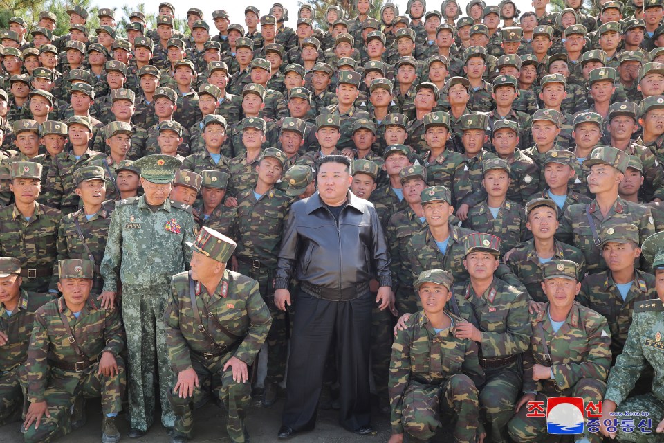 North Korea’s leader Kim Jong Un posing with troops during an inspection at a training base on October 2