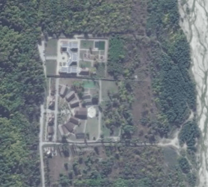 an aerial view of a residential area surrounded by trees