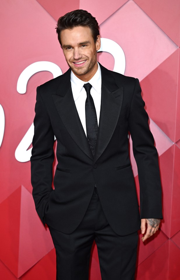 a man in a suit and tie smiles for the camera