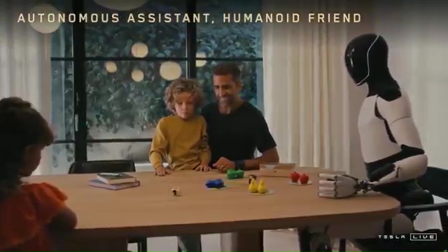 a robot is sitting at a table with a man and two children