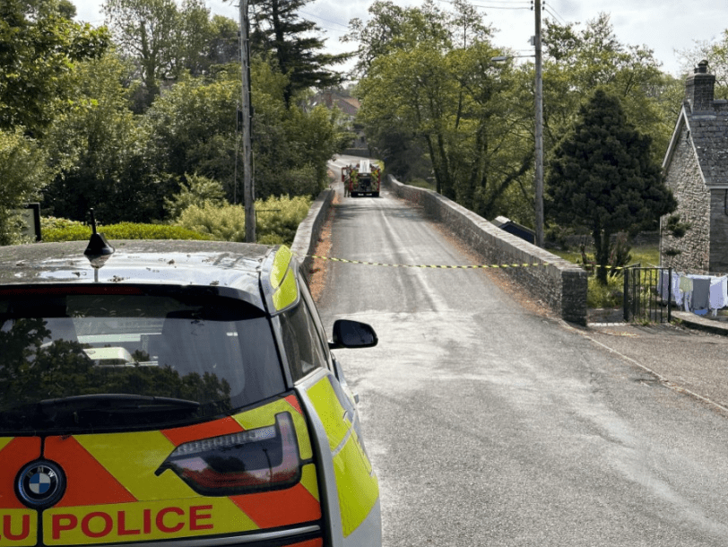 a police car is parked on the side of the road