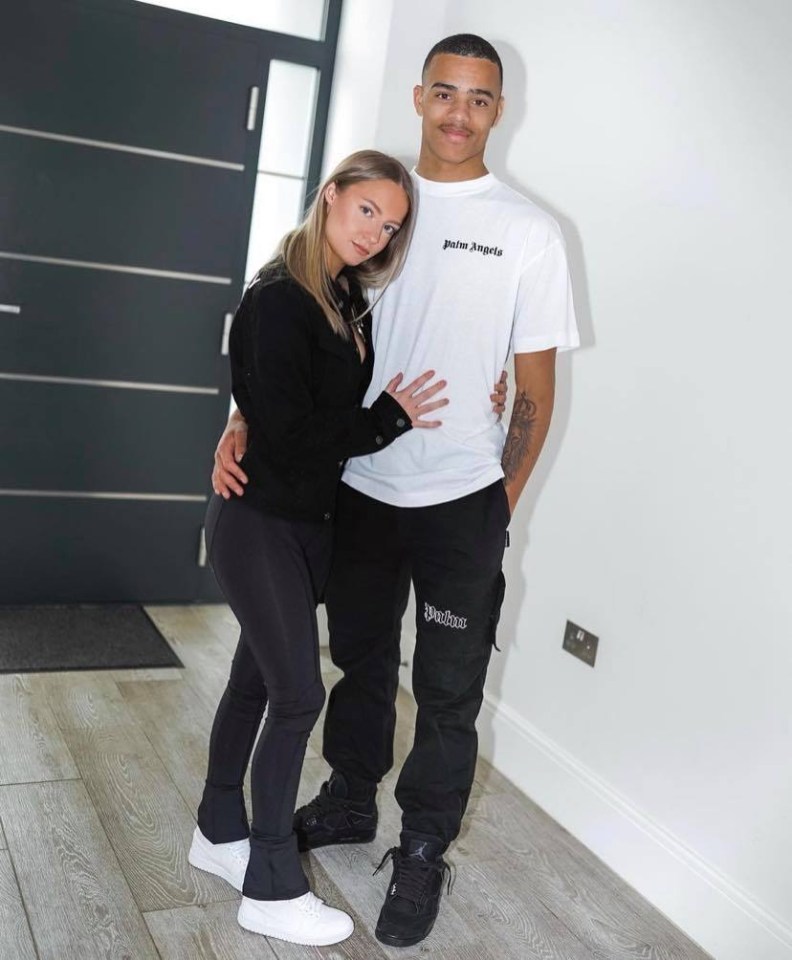 a man wearing a white palm angels t-shirt stands next to a woman