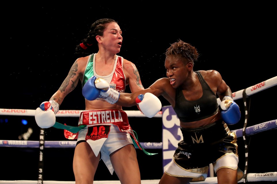 a female boxer wears a belt that says estrella on it