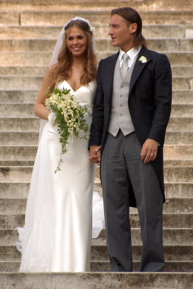 a bride and groom holding hands on a set of stairs