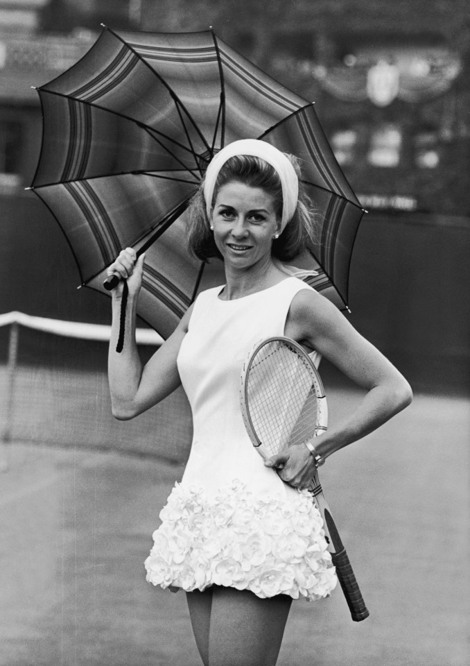 Pericoli wearing a rose-trimmed tennis dress designed by Teddy Tinling at Wimbledon, 1965