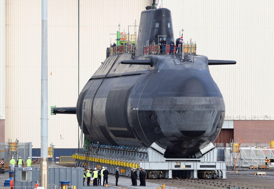 a large submarine is being loaded onto a trailer with a sign that says exit