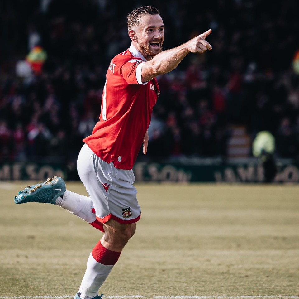 a soccer player wearing a red jersey with the number 1 on it