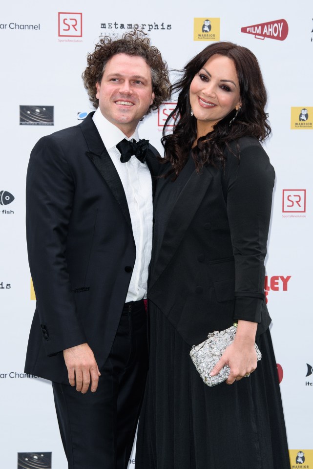 a man and woman are posing for a picture in front of a sign that says film ahoy