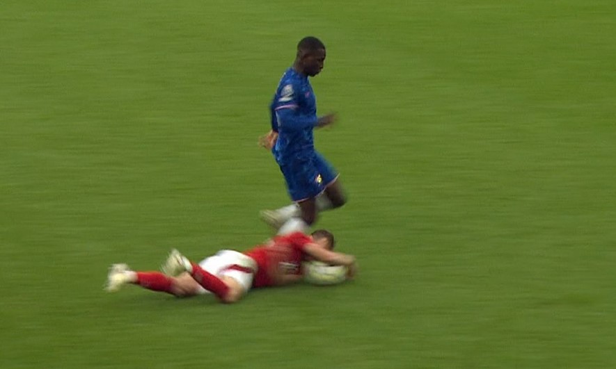 two soccer players are playing a game of soccer on a field .