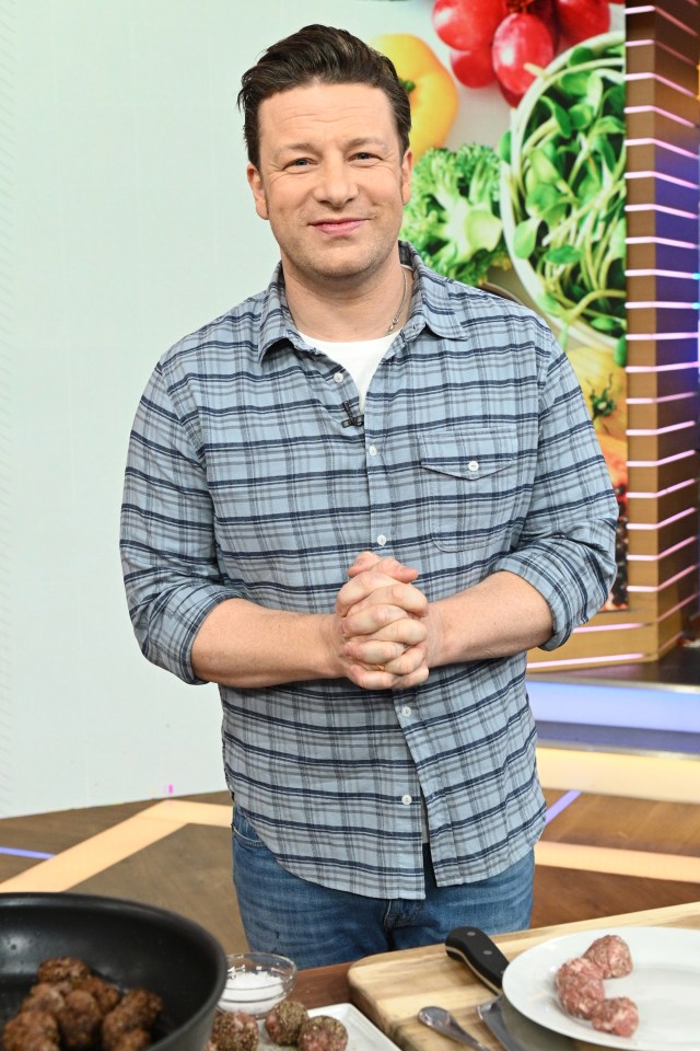 a man in a plaid shirt stands in front of a plate of meatballs