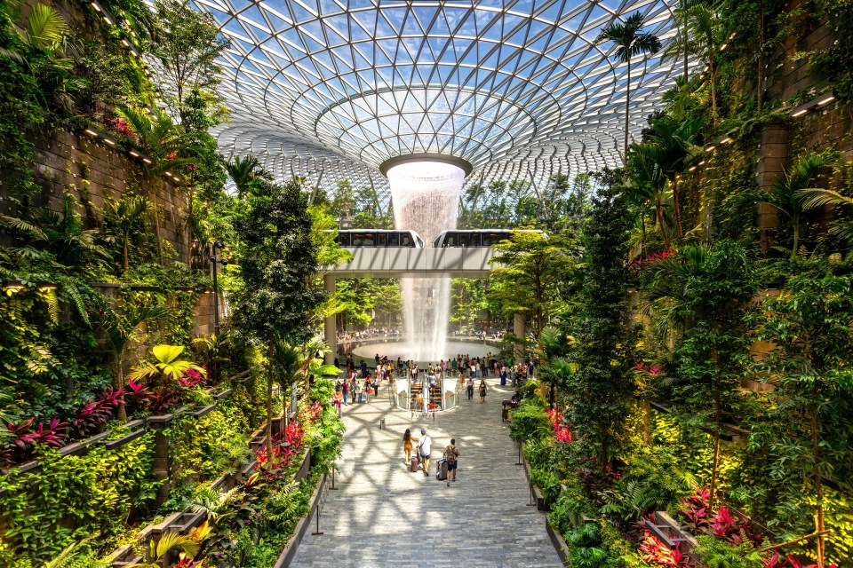 a large building with lots of plants and trees