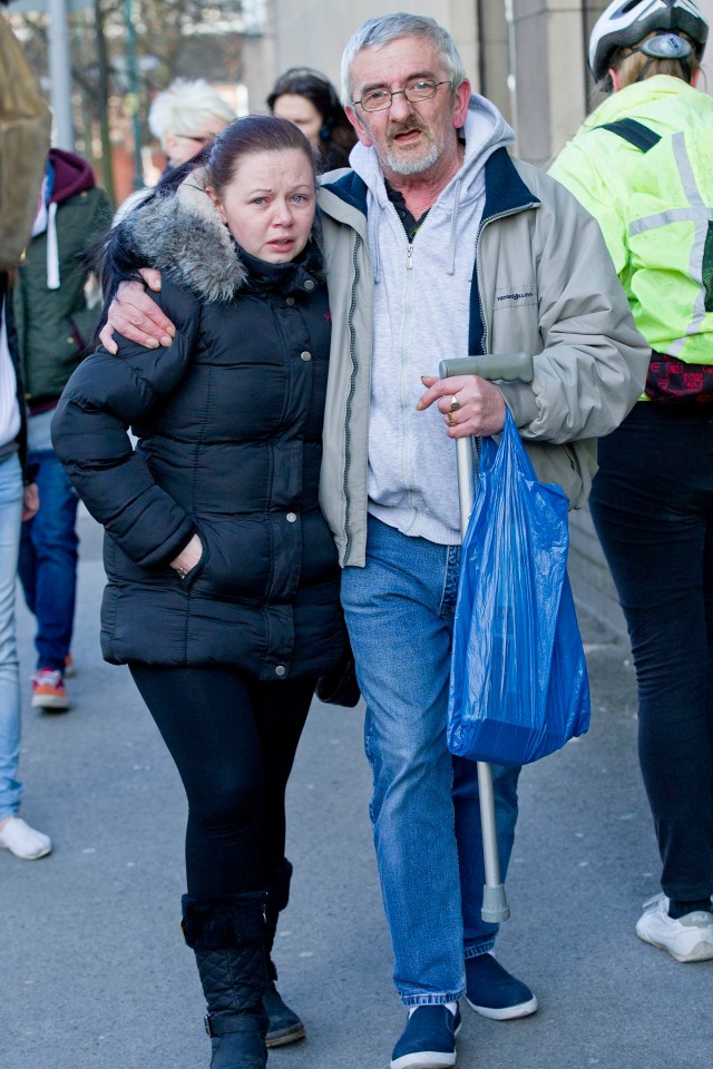 a man with crutches is walking with a woman who is crying