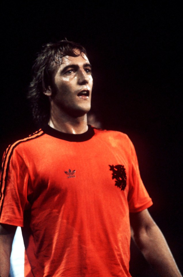 a man is wearing an orange adidas shirt