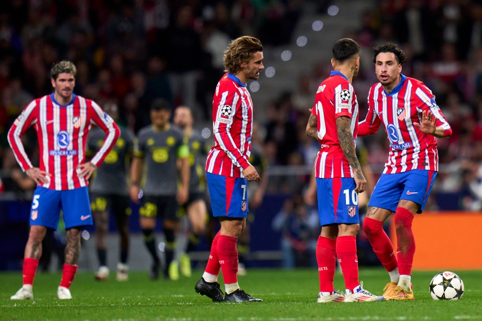 a group of soccer players with one wearing the number 10