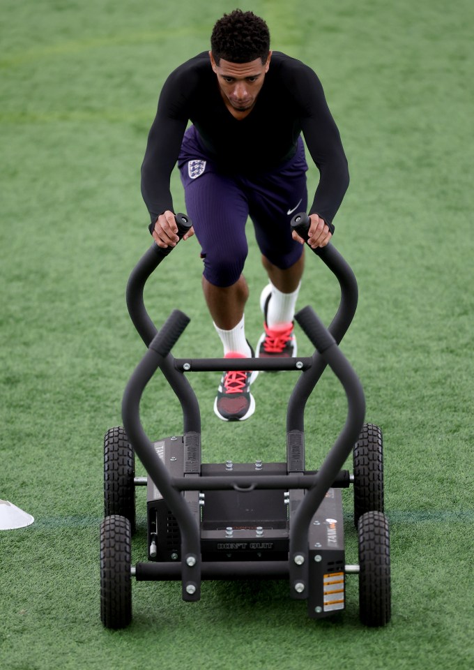 a man wearing a black shirt and purple shorts is pushing a machine that says ' stealth ' on it