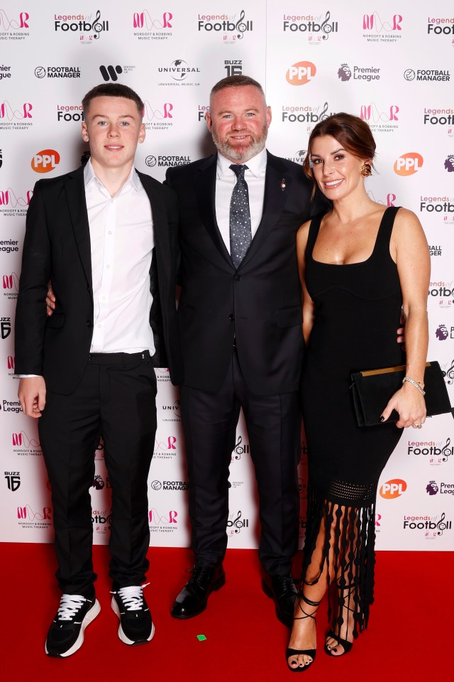 a man in a suit and tie stands next to a woman in a black dress