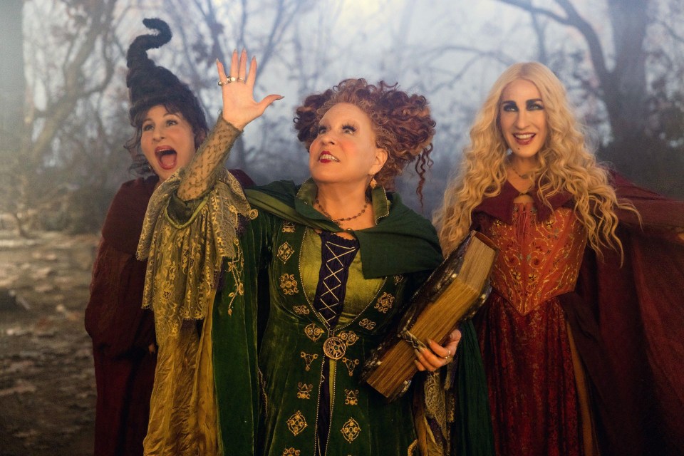 three women dressed as witches are standing next to each other