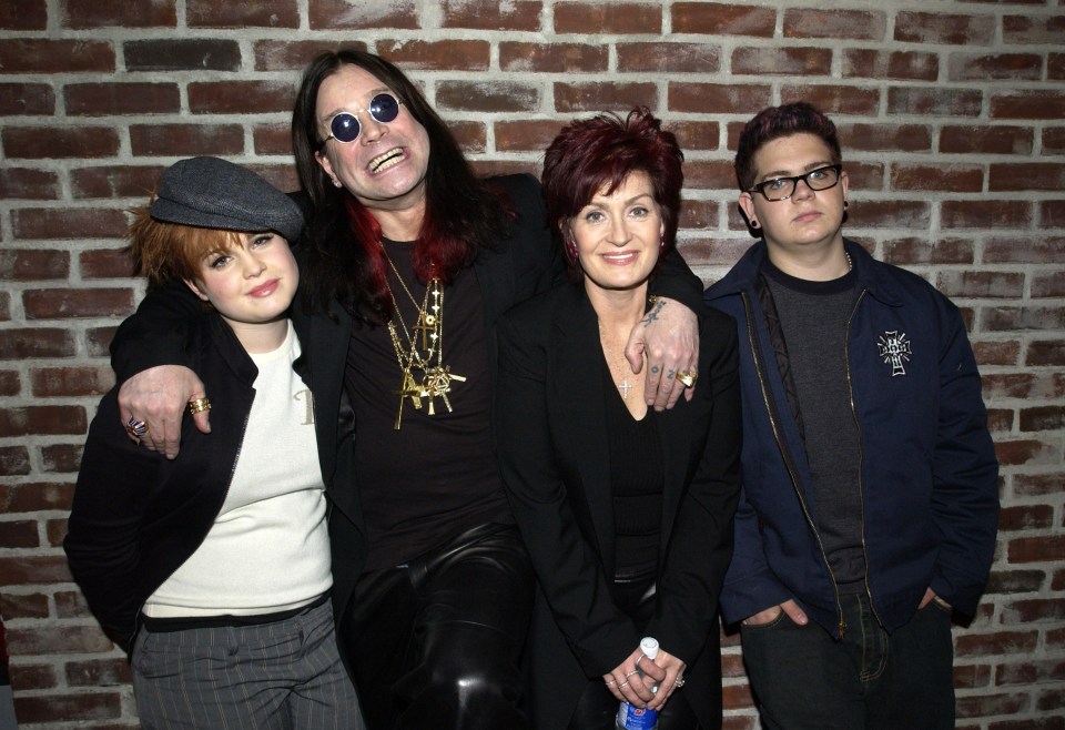 a family posing for a picture in front of a brick wall