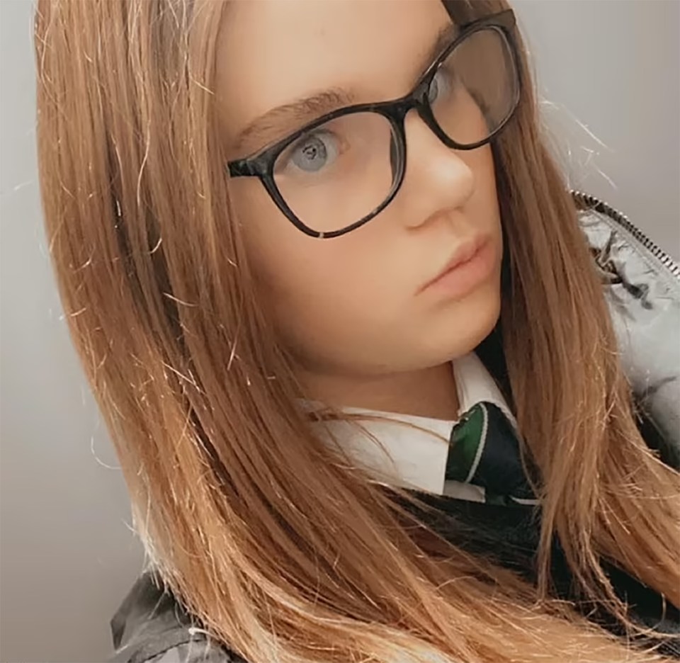 a young girl wearing glasses and a green tie