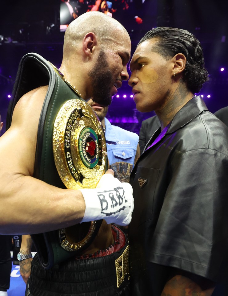 two boxers looking at each other with one wearing a belt that says b.b.b.e.