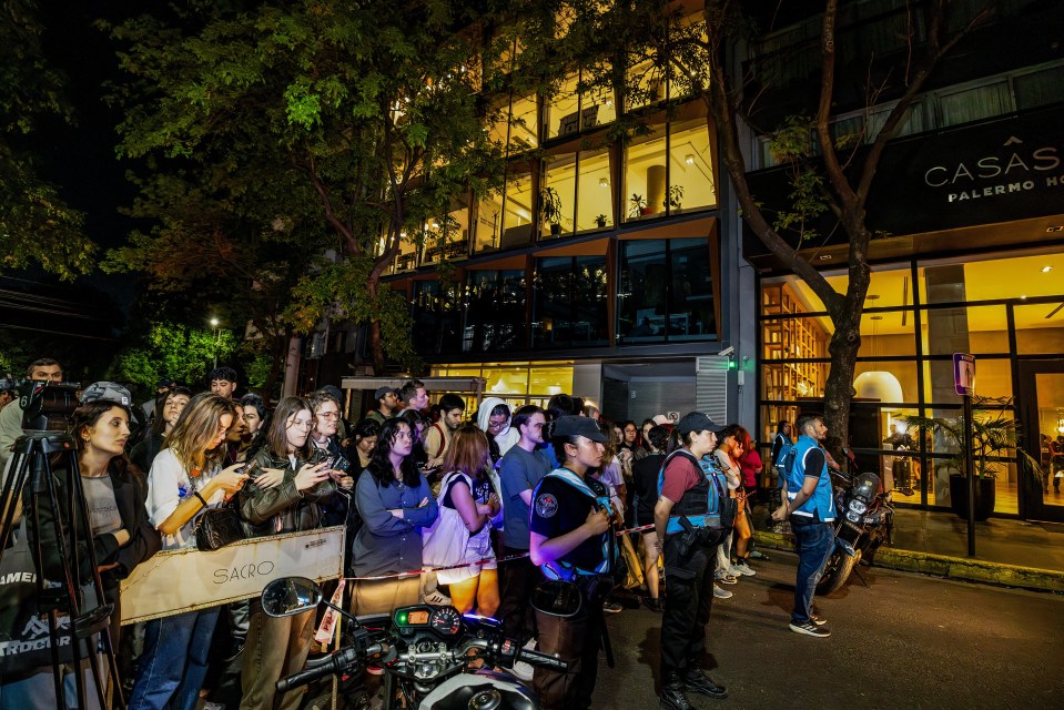 a group of people standing outside of casas palermo hotel