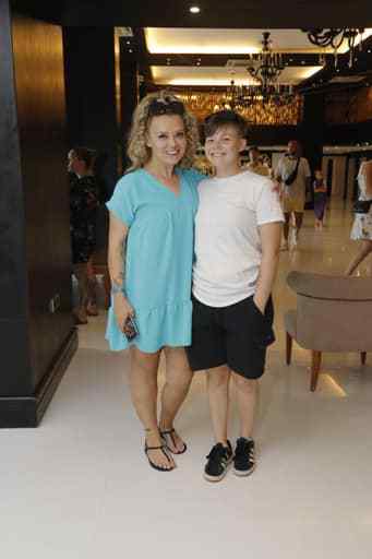 a woman and a boy are posing for a picture in a hotel lobby .