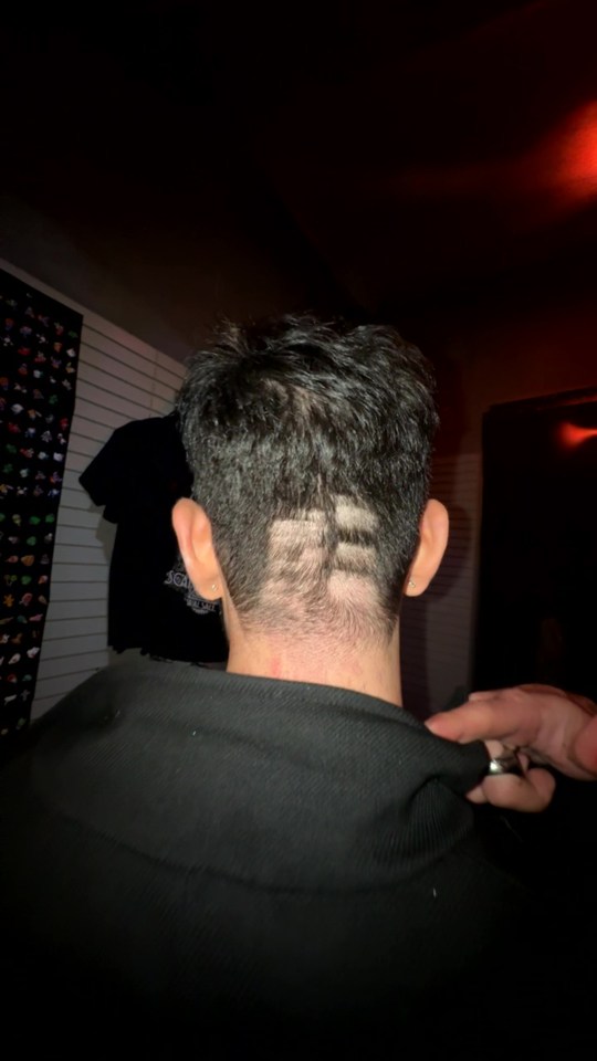 a man with a shaved design in his hair