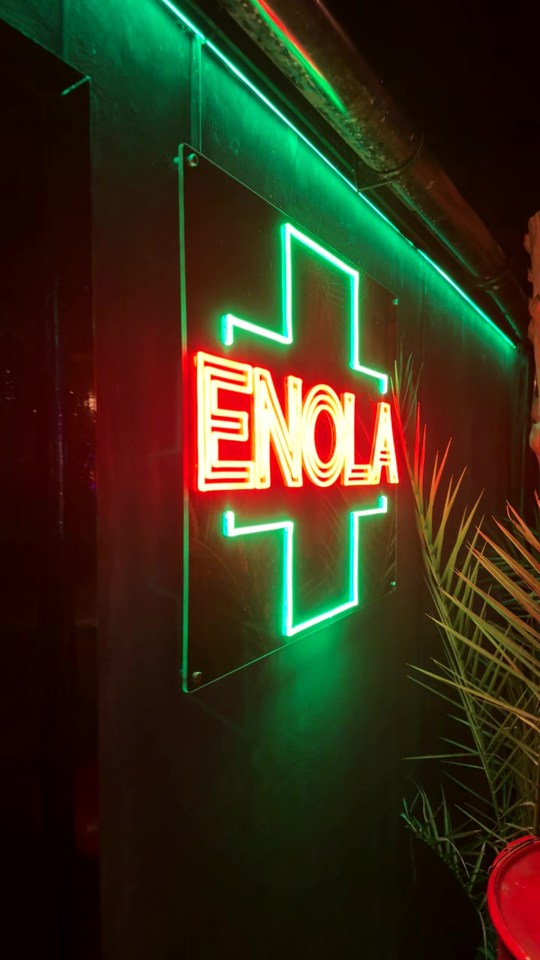 a neon sign that says enola on it