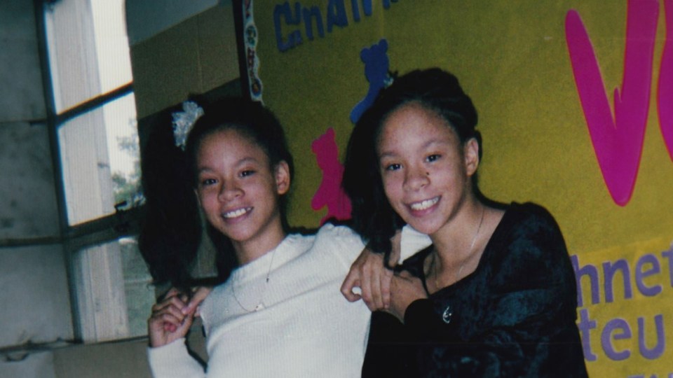 two girls are posing for a picture in front of a wall that says chanteu