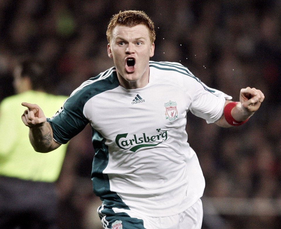 a soccer player wearing a carlsberg jersey celebrates