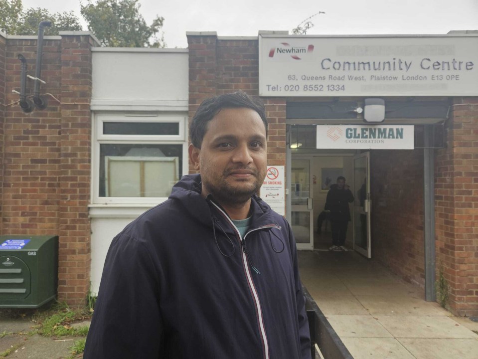 a man stands in front of the newham community centre