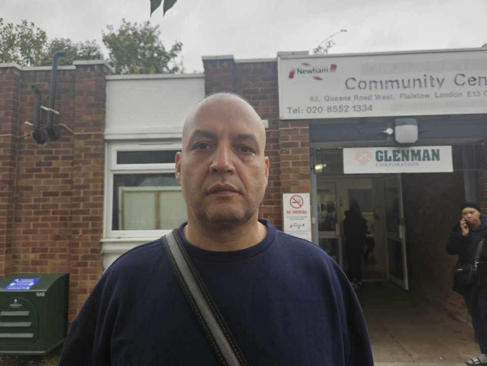 a man stands in front of a community center