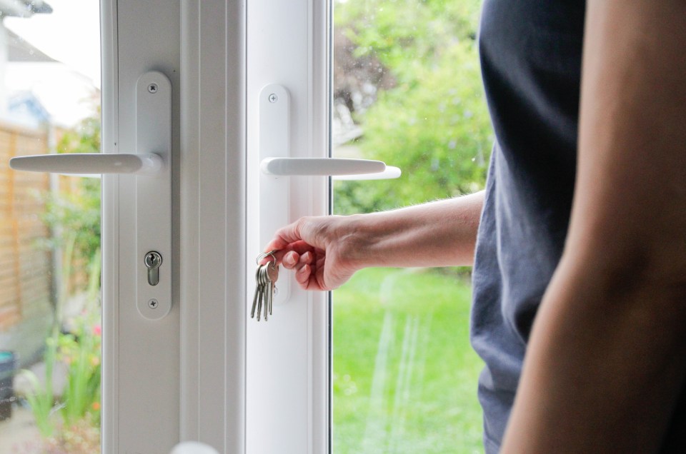 a person is opening a door with a bunch of keys in their hand