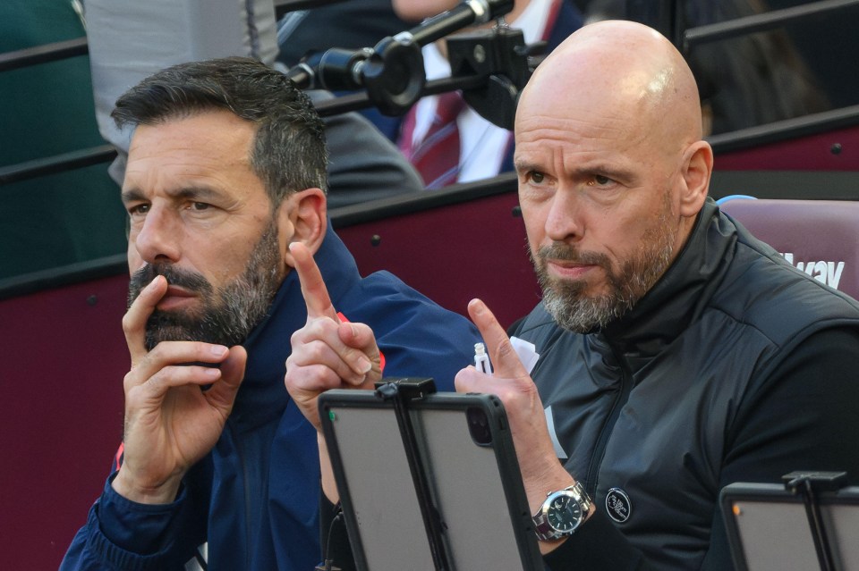 two men are sitting in a stadium and one has a watch on