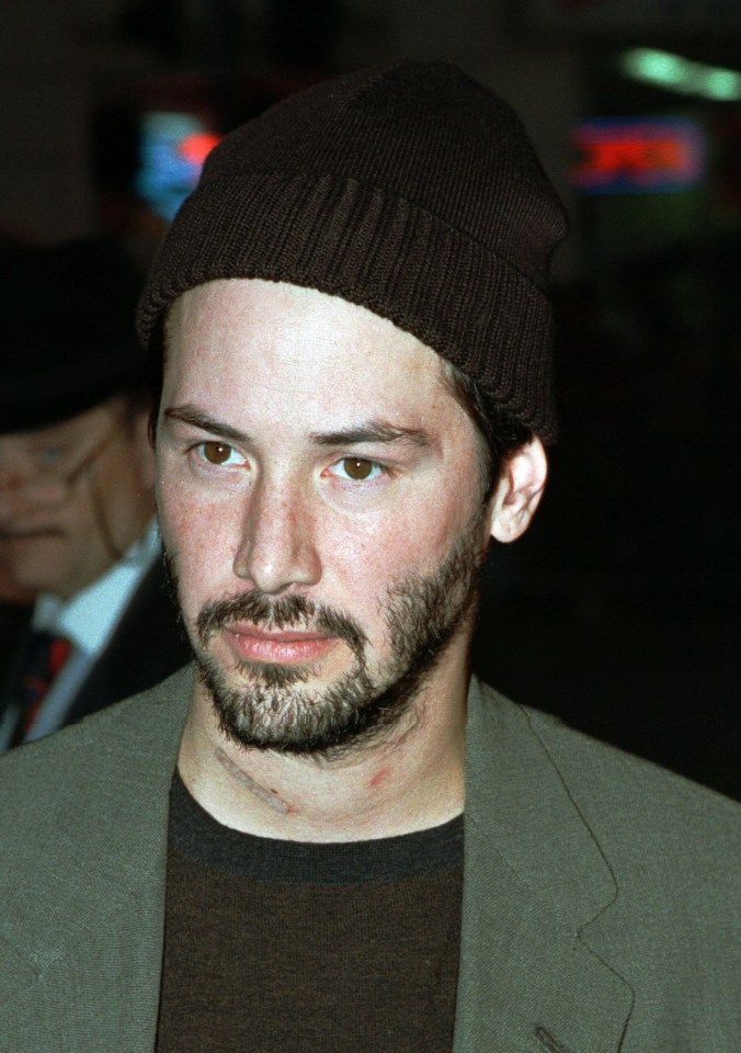 a man with a beard wearing a brown beanie