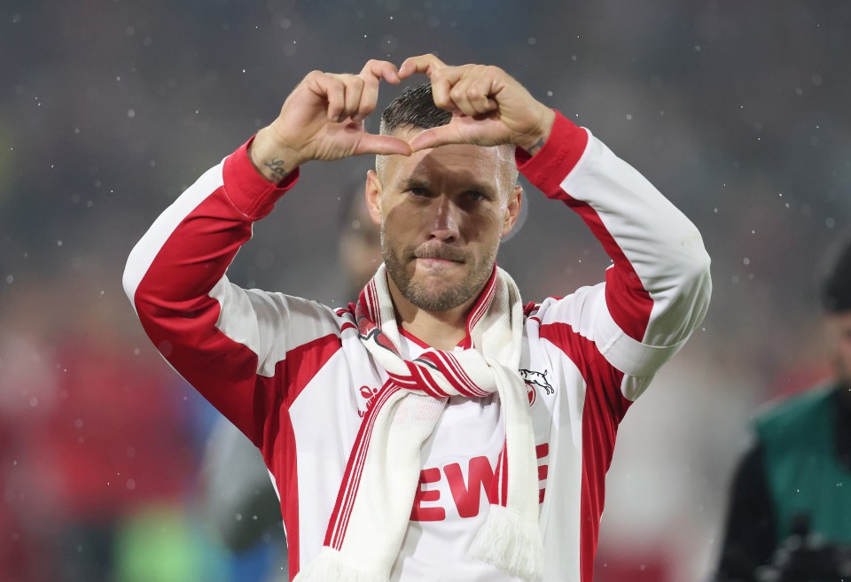 a man wearing a red and white jersey with the word ew on it