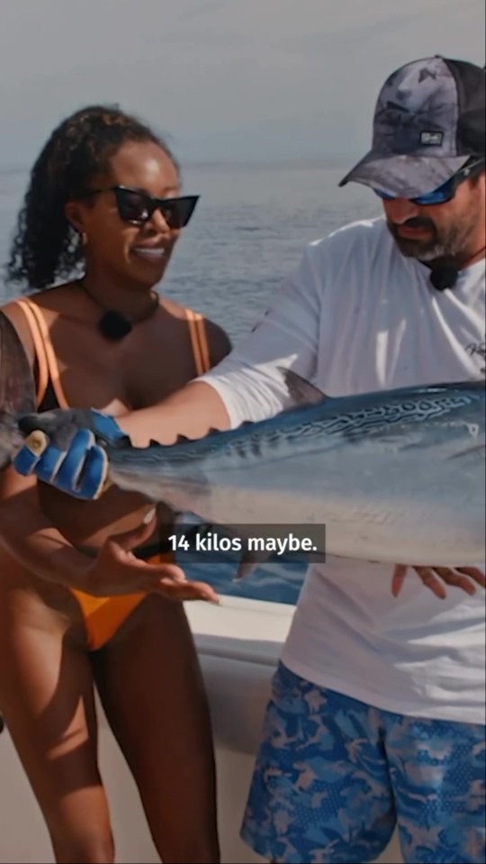 a man is holding a large fish with the caption 14 kilos maybe