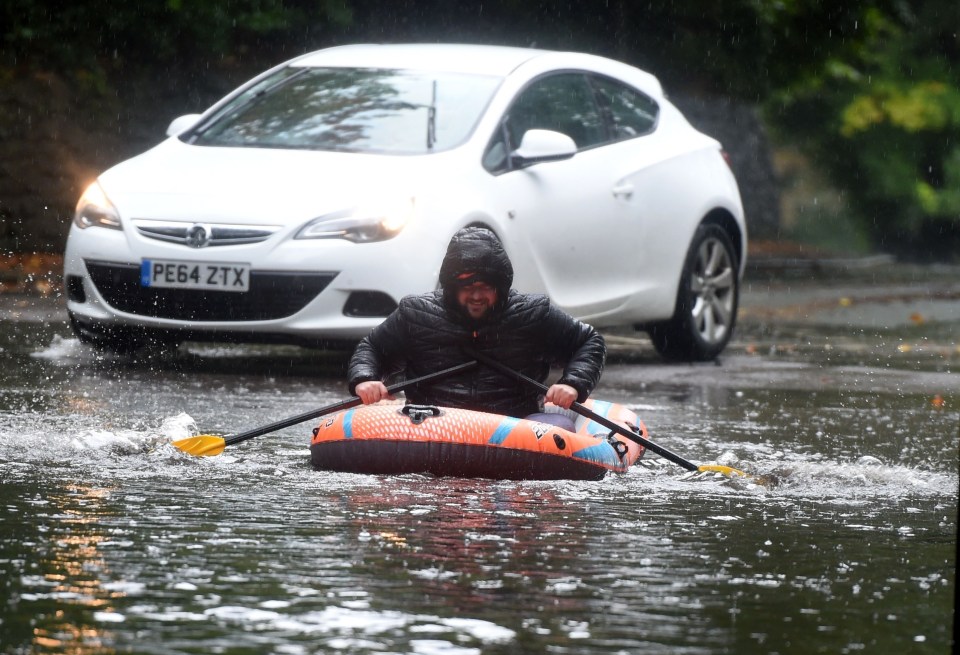 A man makes the most of the wet weather in Cheshire yesterday