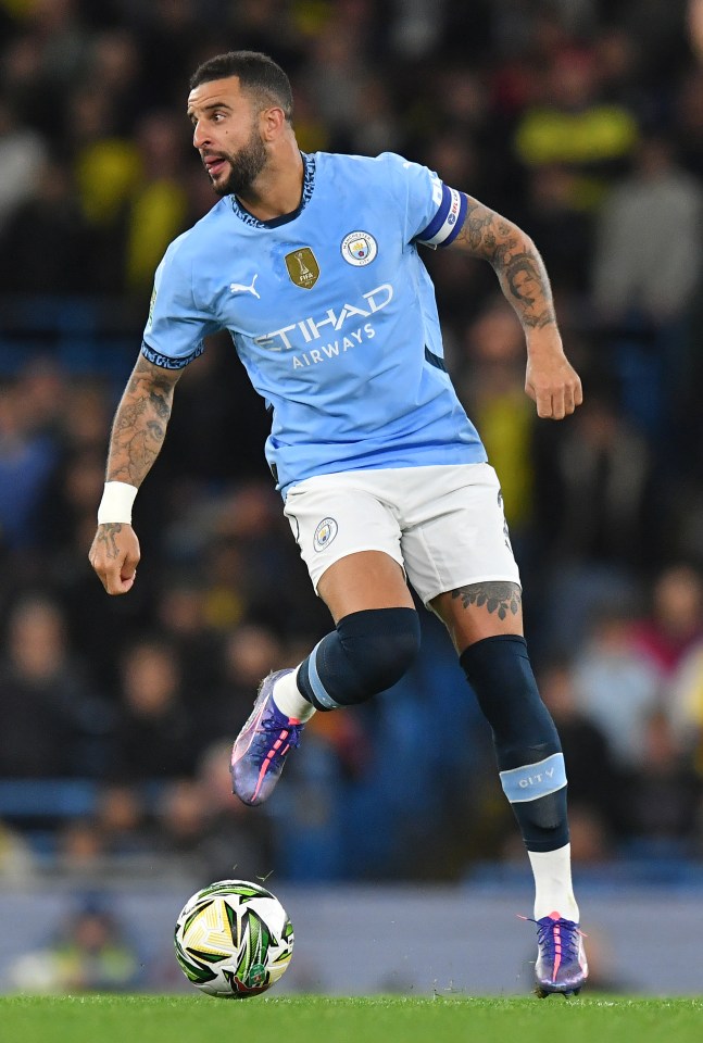 a soccer player wearing a blue shirt that says etihad airways