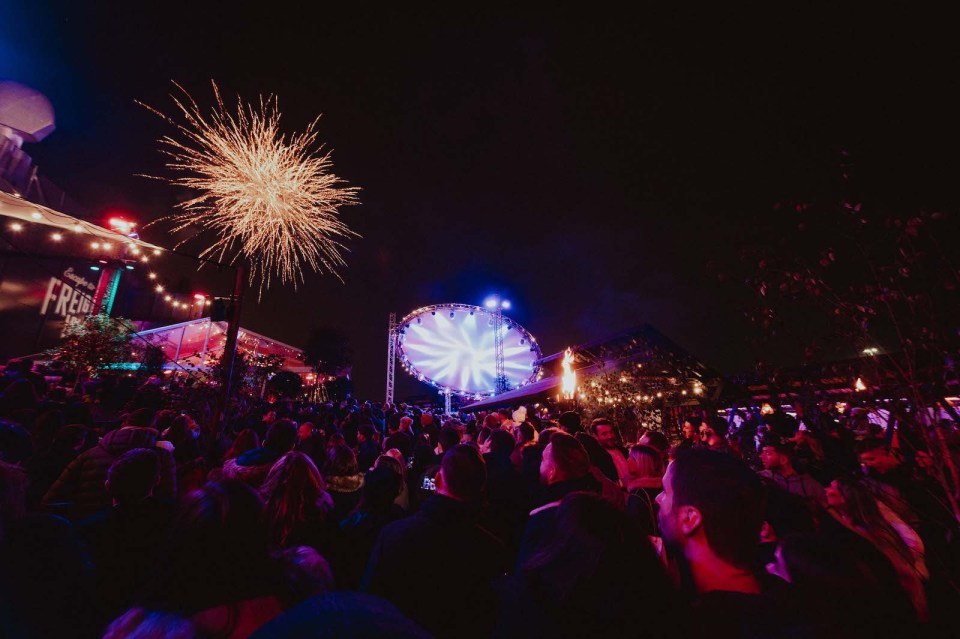 a crowd of people are gathered in front of a sign that says freak