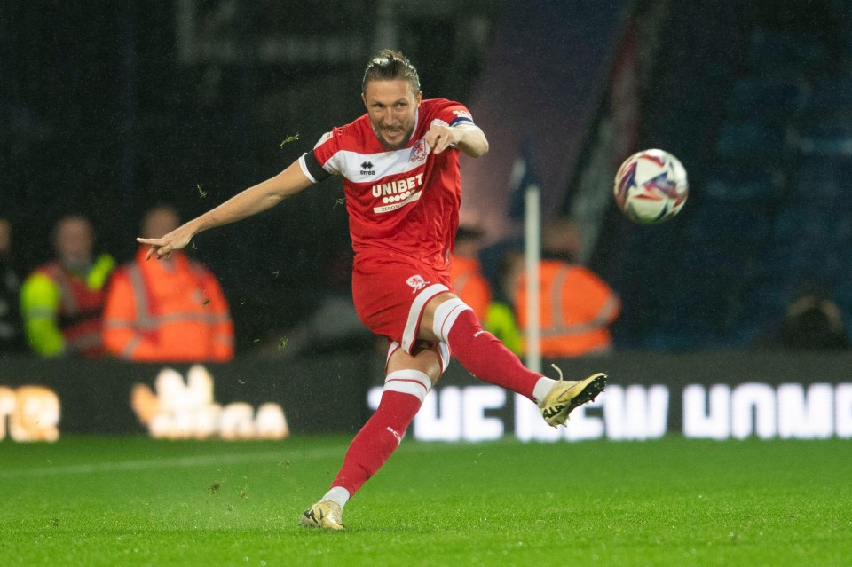 a soccer player in a red uniform with the word unibet on it