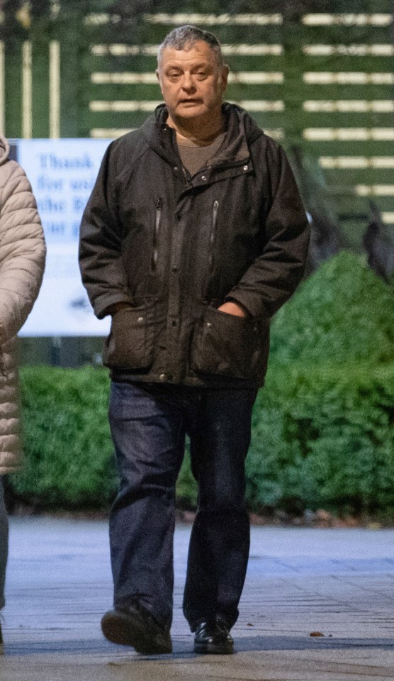 a man walking in front of a sign that says thank you