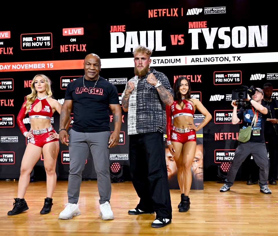 a group of people standing in front of a sign that says paul vs tyson