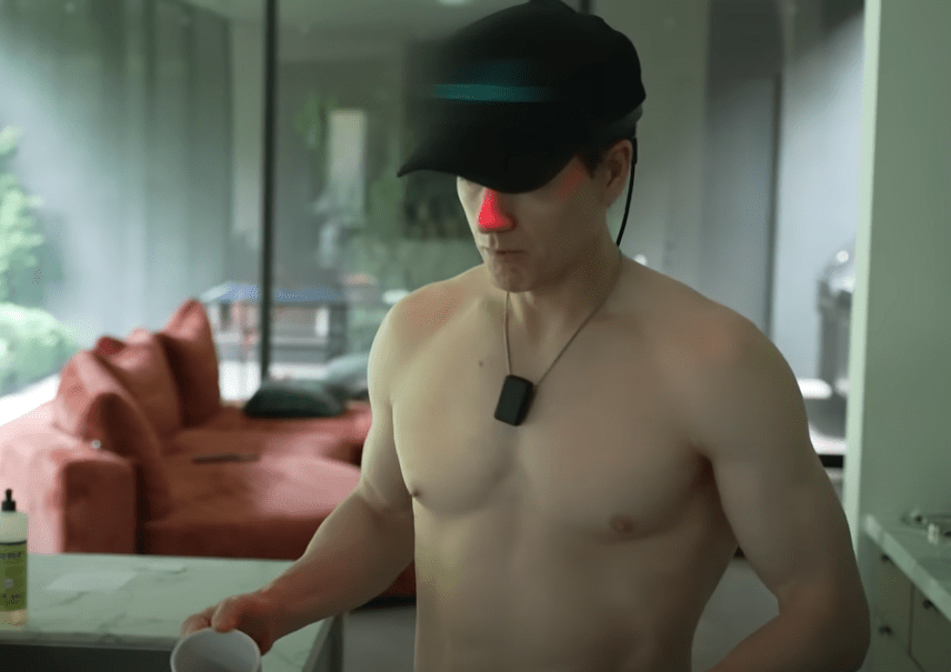 The millionaire biohacker frequently dons a red light cap while doing his morning routine