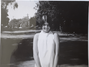 a black and white photo of a woman in a white dress